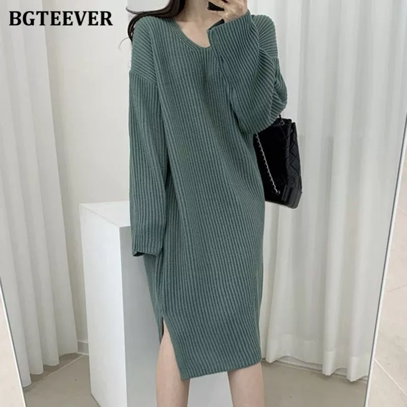 Vestito lungo verde con scollo a V e tessuto a costine, maniche lunghe su modello femminile