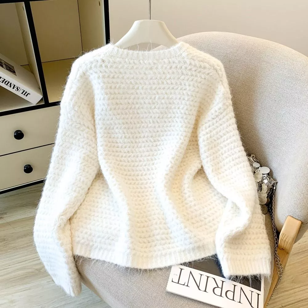 Dettaglio del cardigan giallo con texture a maglia e bottoni rivestiti