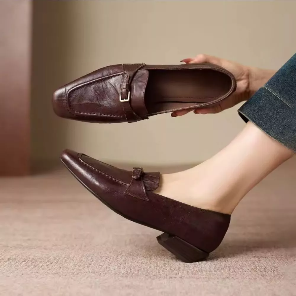 Mocassino donna marrone indossato con dettagli fibbia e tacco basso quadrato